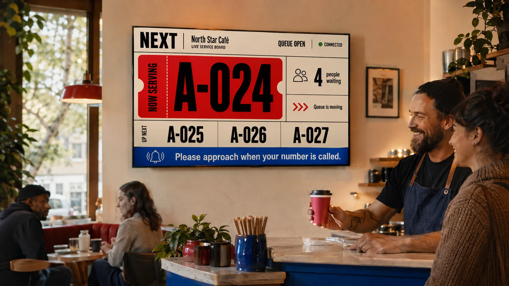 The NEXT public queue display mounted above the service counter at North Star Café.